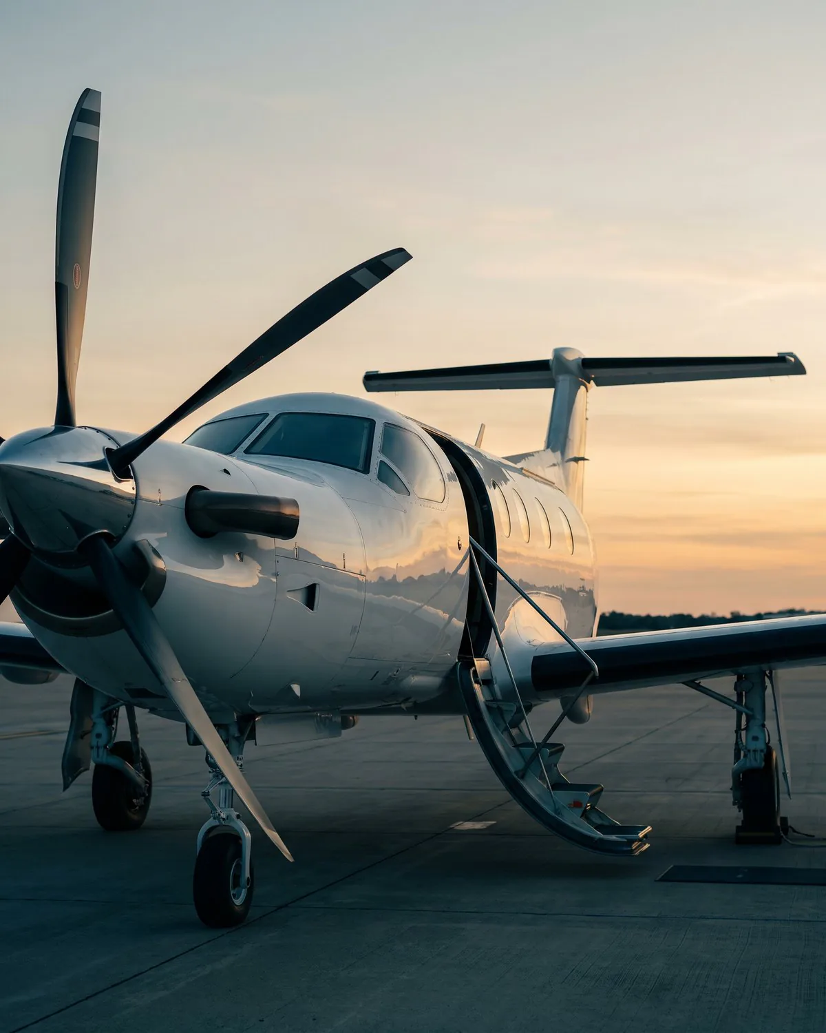 Single-engine turboprop on the ramp at a South Florida executive airport at sunrise